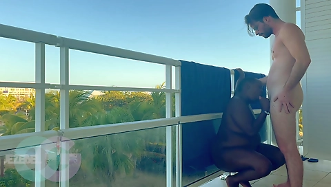 Curvy girl with a great booty is having fun on a balcony